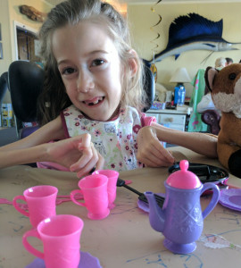 Callie with her tea set at the beach