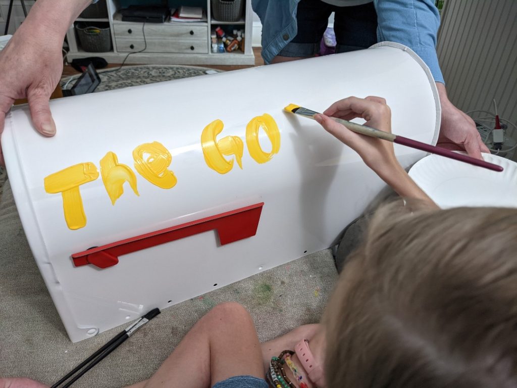 Painting her mailbox